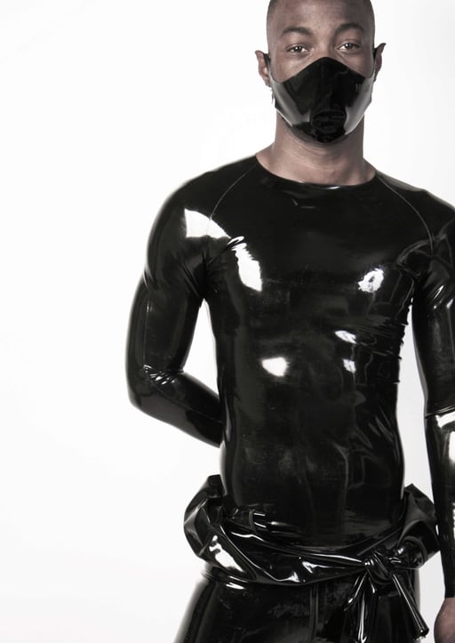 Male model with a solid black rubber face mask