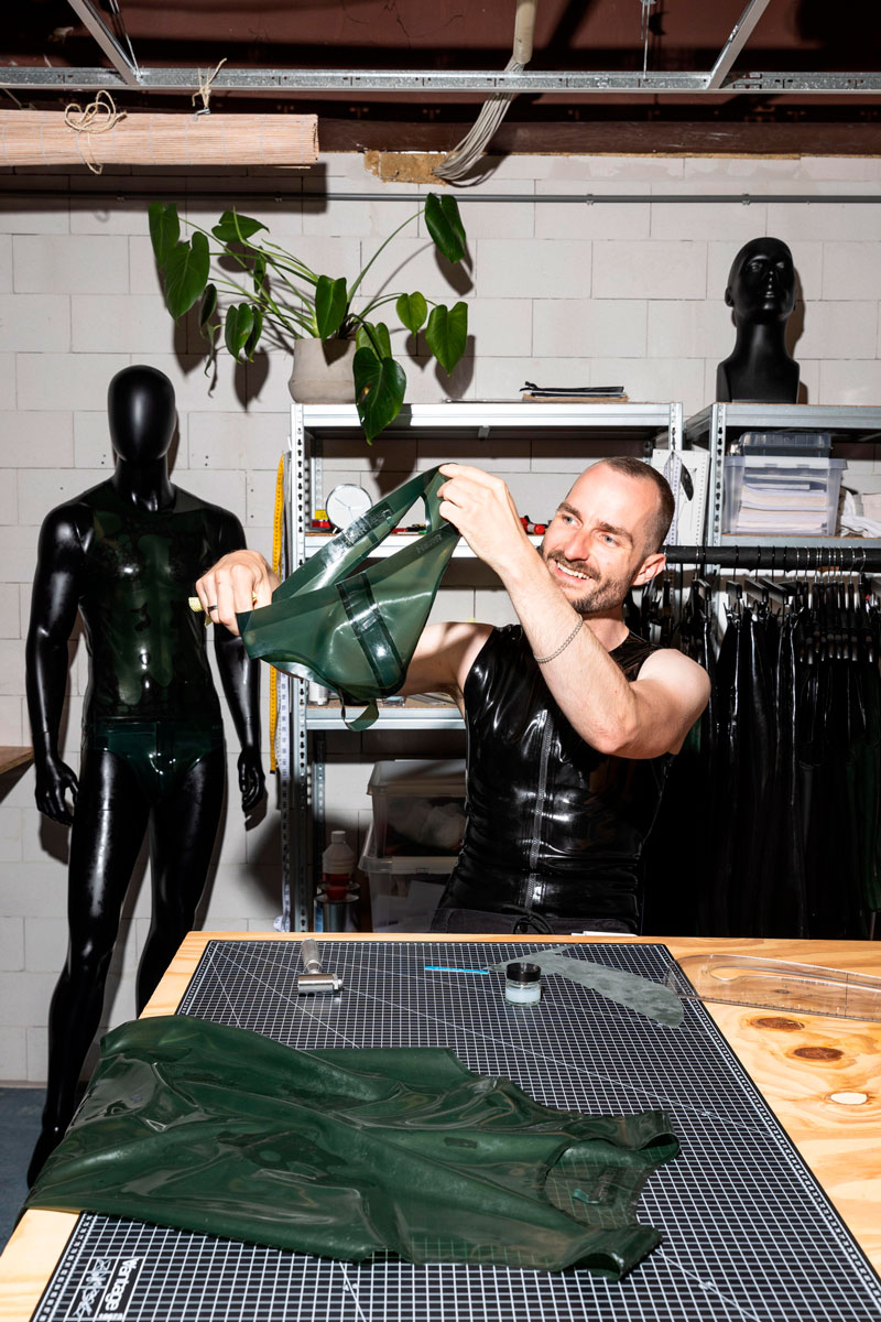 HERR Jouke Halma showing a green rubber jockstrap in his workshop
